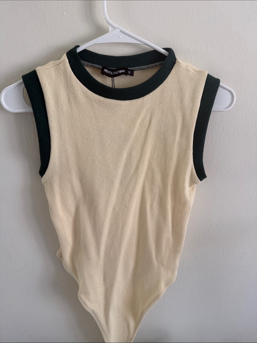 PrettyLittleThing Cream Ribbed Sleeveless Bodysuit with Black Trim